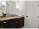Traditional bathroom with dark vanity, granite countertop, and decorative flowers at 5140 Long Island Nw Dr, Sandy Springs, GA 30327