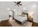 Charming bedroom featuring stylish decor, wood floors, and abundant natural light through shuttered windows at 5140 Long Island Nw Dr, Sandy Springs, GA 30327