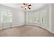 Bright bedroom featuring neutral walls, carpet, a ceiling fan and large windows with plantation shutters at 5140 Long Island Nw Dr, Sandy Springs, GA 30327