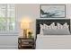 Comfortable bedroom shows stylish decor, including a cozy lamp and a view to the outside at 5140 Long Island Nw Dr, Sandy Springs, GA 30327