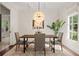 Dining room with a chandelier, neutral walls, and light colored hardwood floors at 5140 Long Island Nw Dr, Sandy Springs, GA 30327