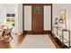 Foyer featuring hardwood floors, a front door, and a decorative console table at 5140 Long Island Nw Dr, Sandy Springs, GA 30327