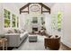 Bright living room with high ceilings, wood beams, fireplace, and an abundance of natural light at 5140 Long Island Nw Dr, Sandy Springs, GA 30327