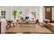 Cozy living room featuring stylish furniture, hardwood floors, and lots of natural light at 5140 Long Island Nw Dr, Sandy Springs, GA 30327