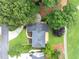 An aerial view shows the property surrounded by mature trees and a well-maintained lawn at 10300 Carleigh Ln, Roswell, GA 30076