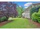 Well-manicured lawn and mature trees create a serene backyard setting at 10300 Carleigh Ln, Roswell, GA 30076