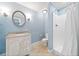 Bathroom with single sink vanity, tiled floors and a stand up shower at 10300 Carleigh Ln, Roswell, GA 30076