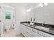 Bright bathroom with double sinks, granite counters, and ample cabinet space at 10300 Carleigh Ln, Roswell, GA 30076