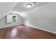 Bright bedroom with hardwood floors and a large window with plantation shutters at 10300 Carleigh Ln, Roswell, GA 30076