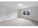 Bright bedroom with plush carpeting, a double window, and ample natural light at 10300 Carleigh Ln, Roswell, GA 30076