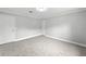 Spacious bedroom with plush carpeting, neutral walls, and two entry doors at 10300 Carleigh Ln, Roswell, GA 30076