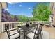 Large wooden deck with an outdoor dining table and backyard views in a natural setting at 10300 Carleigh Ln, Roswell, GA 30076