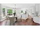 Bright dining area with large windows and backyard views next to the modern kitchen at 10300 Carleigh Ln, Roswell, GA 30076