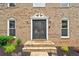 Elegant entryway with double doors, stone steps and manicured landscaping at 10300 Carleigh Ln, Roswell, GA 30076