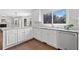 Bright kitchen with white cabinets, granite countertops, and stainless steel appliances at 10300 Carleigh Ln, Roswell, GA 30076