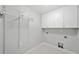 Functional laundry room with white cabinets and ample storage space at 10300 Carleigh Ln, Roswell, GA 30076