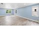 Bright living room featuring wood-look floors, recessed lighting, and large windows at 10300 Carleigh Ln, Roswell, GA 30076