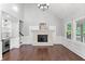 Well-lit living room with a fireplace, built-in shelves, and access to the backyard at 10300 Carleigh Ln, Roswell, GA 30076