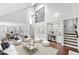 Bright living room with wet bar, high ceilings, and staircase to the second floor at 10300 Carleigh Ln, Roswell, GA 30076