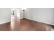 Spacious living room boasts gleaming hardwood floors and neutral paint at 10300 Carleigh Ln, Roswell, GA 30076
