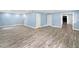 Spacious living room featuring wood-look floors, and doors at 10300 Carleigh Ln, Roswell, GA 30076