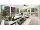Cozy screened-in porch with a ceiling fan and outdoor furniture and backyard view at 10300 Carleigh Ln, Roswell, GA 30076