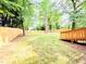 Scenic backyard with wooden fence, lush lawn, and mature trees for serene outdoor enjoyment at 2190 Gordon Se Cir, Smyrna, GA 30080