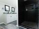 Modern bathroom featuring black tiled shower, white vanity, and stylish fixtures at 2190 Gordon Se Cir, Smyrna, GA 30080