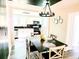 Dining room with a modern table, decorative chandelier, and view into the kitchen at 2190 Gordon Se Cir, Smyrna, GA 30080