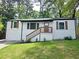 Charming single-Gathering home with white siding, inviting front porch, and well-manicured lawn at 2190 Gordon Se Cir, Smyrna, GA 30080