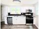 Modern kitchen with white cabinets, granite countertops, stainless steel appliances, and sleek backsplash at 2190 Gordon Se Cir, Smyrna, GA 30080