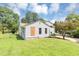 Backyard showing the house with mature trees and a well-manicured lawn at 2767 Kathie Ln, Ellenwood, GA 30294