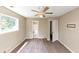 Bedroom with hardwood floors, ceiling fan, and an ensuite bathroom entrance at 2767 Kathie Ln, Ellenwood, GA 30294