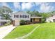 Charming split-level home featuring well-maintained lawn, driveway and classic architectural details at 2767 Kathie Ln, Ellenwood, GA 30294