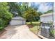 Detached garage with driveway and mature trees in the backyard of the house at 2767 Kathie Ln, Ellenwood, GA 30294