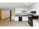 Kitchen featuring white cabinets, tile floors, and an open layout at 2767 Kathie Ln, Ellenwood, GA 30294