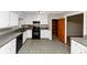 Kitchen featuring white cabinets, tile floors, and an open layout at 2767 Kathie Ln, Ellenwood, GA 30294