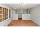 Empty living room featuring weathered floors, natural light, and columns at 2767 Kathie Ln, Ellenwood, GA 30294