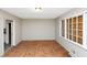 Empty living room featuring weathered floors and natural light at 2767 Kathie Ln, Ellenwood, GA 30294