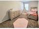 This cozy bedroom features a twin bed, dresser, and a playful teepee, creating a comfortable and inviting space at 3341 Sable Elm Ct, Atlanta, GA 30349