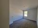 A well-lit room with plush carpeting, featuring neutral walls and natural light, creates a simple, cozy atmosphere at 3341 Sable Elm Ct, Atlanta, GA 30349