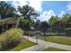 The community pool is surrounded by mature trees and features a black fence, a ramp and an umbrella table at 3341 Sable Elm Ct, Atlanta, GA 30349