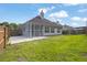 Spacious backyard featuring a screened porch, patio, and lawn with a wood fence at 3946 Village Crossing Ln, Ellenwood, GA 30294