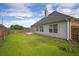 Exterior view of backyard featuring a porch, patio, and lawn with privacy fence at 3946 Village Crossing Ln, Ellenwood, GA 30294