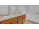 Neutral bathroom with double sinks, tub, and natural light at 3946 Village Crossing Ln, Ellenwood, GA 30294