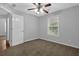 Cozy bedroom with a ceiling fan, window, and white door at 3946 Village Crossing Ln, Ellenwood, GA 30294
