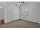 Cozy bedroom with a ceiling fan, window, and closet doors at 3946 Village Crossing Ln, Ellenwood, GA 30294