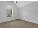 Bright bedroom featuring a large window, neutral carpet, and vaulted ceiling at 3946 Village Crossing Ln, Ellenwood, GA 30294
