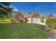 Beautiful brick home with a well-manicured lawn and a two-car garage at 3946 Village Crossing Ln, Ellenwood, GA 30294