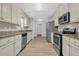 Modern kitchen featuring stainless steel appliances and updated countertops at 3946 Village Crossing Ln, Ellenwood, GA 30294